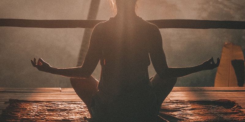 Person meditating peacefully in nature representing calm and balance